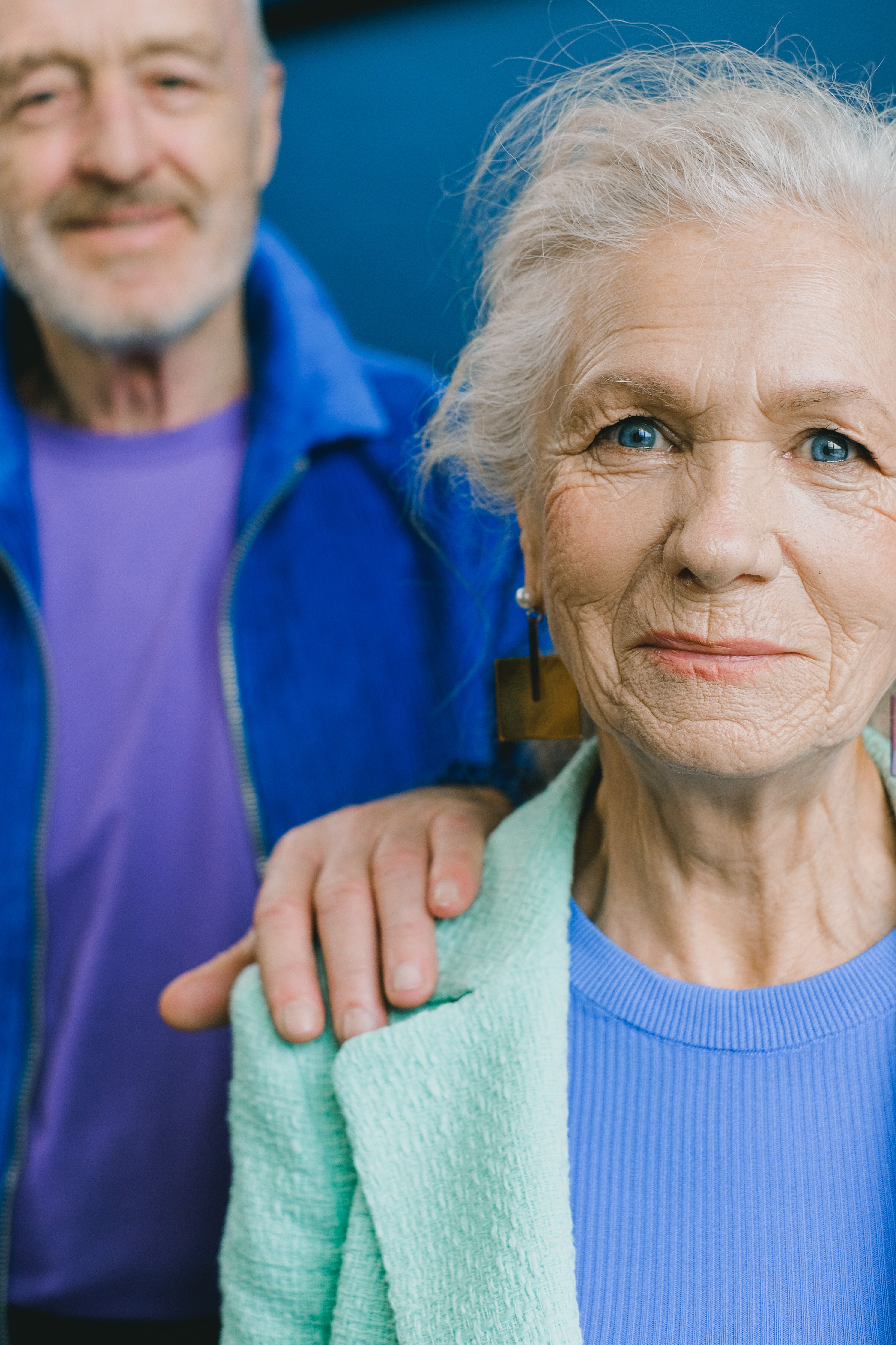 Older couple together, with his hand resting on her shoulder